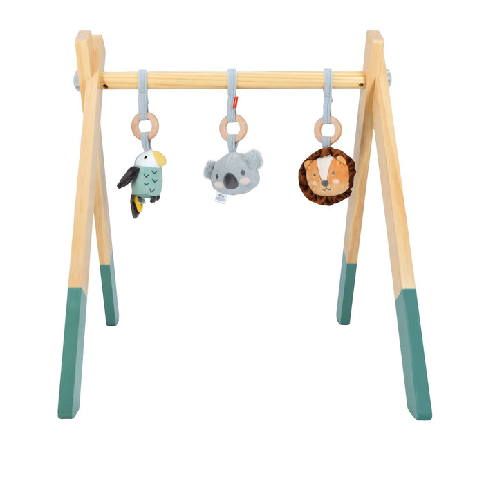 The Wooden Play Gym has green-tipped legs and comes with three hanging toys—a bird, koala, and lion—each suspended by a ring.