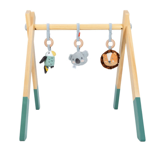 The Wooden Play Gym has green-tipped legs and comes with three hanging toys—a bird, koala, and lion—each suspended by a ring.